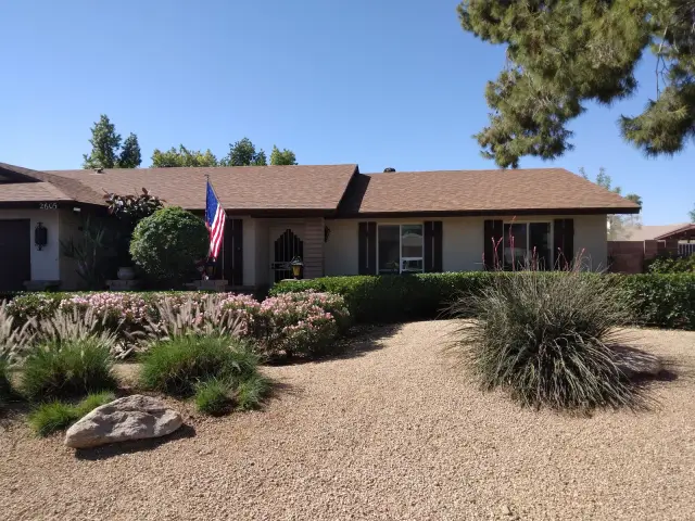 Desert front yard with decorative rock, boulders and agave planting