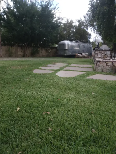 Green lawn with flagstone stepping stones leading across it